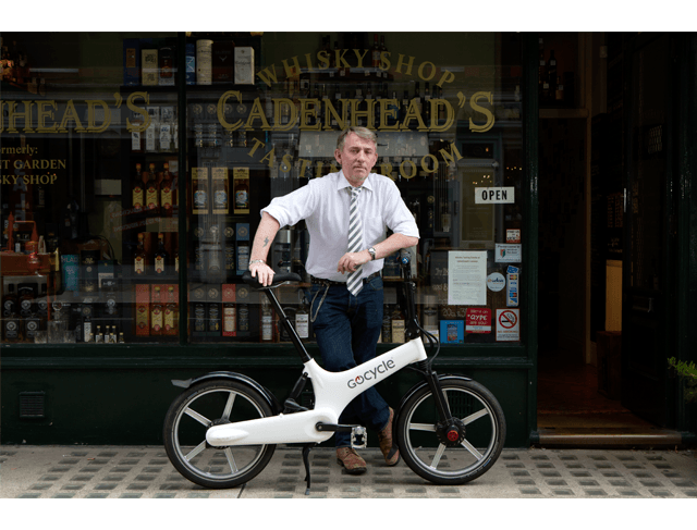 Stephen Worrel and his Gocycle in his Whiskey shop in London.